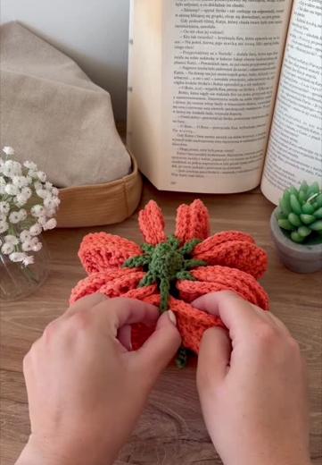 Hands assembling the coasters into a pumpkin