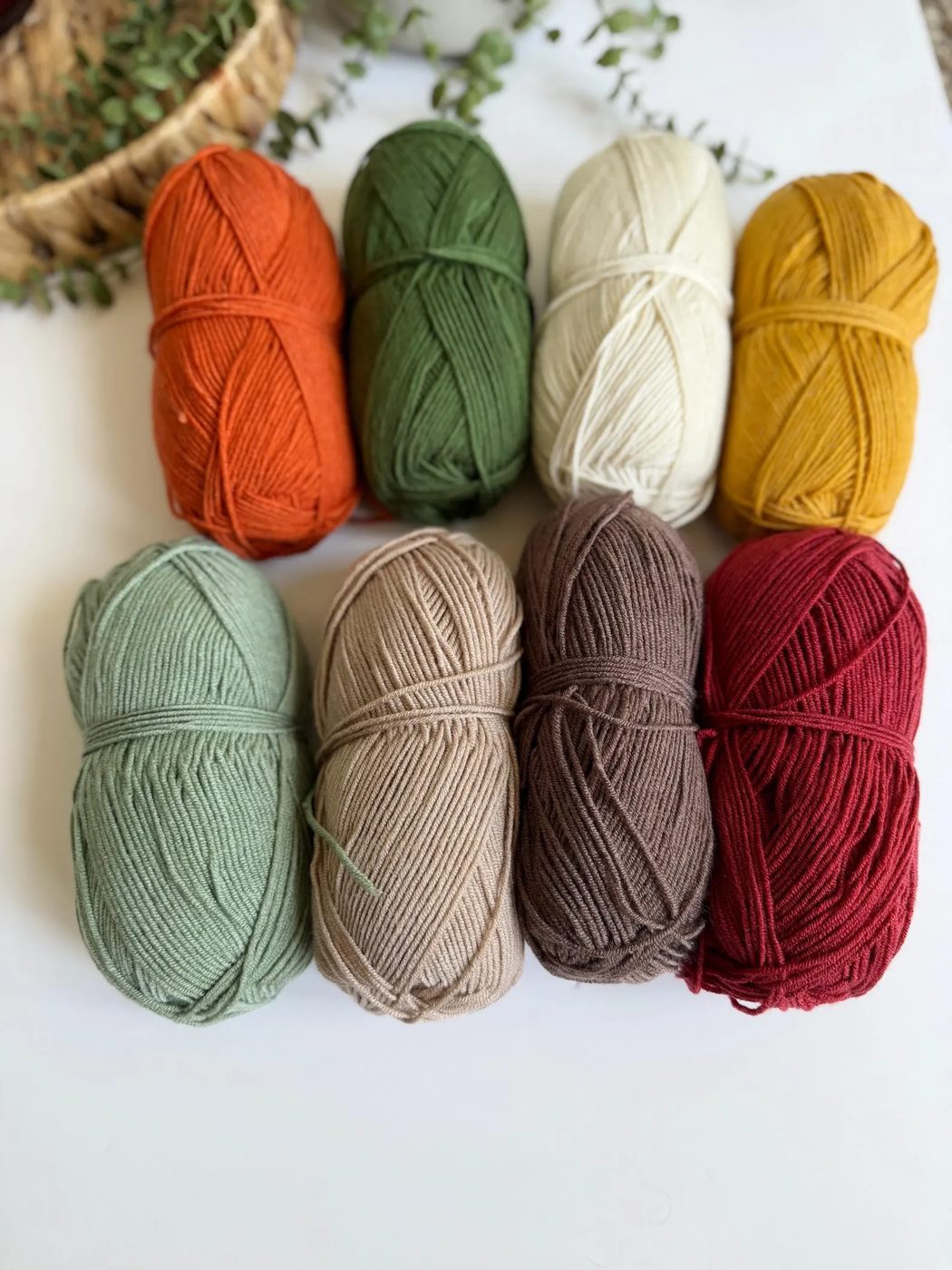 Eight skeins of yarn in autumn colors