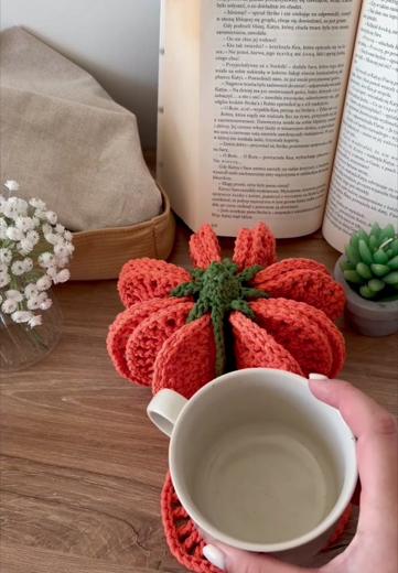A mug resting on a single pumpkin coaster