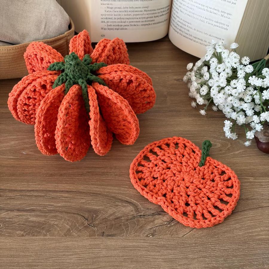 Eight crochet pumpkin coasters assembled into a pumpkin, one coaster beside it
